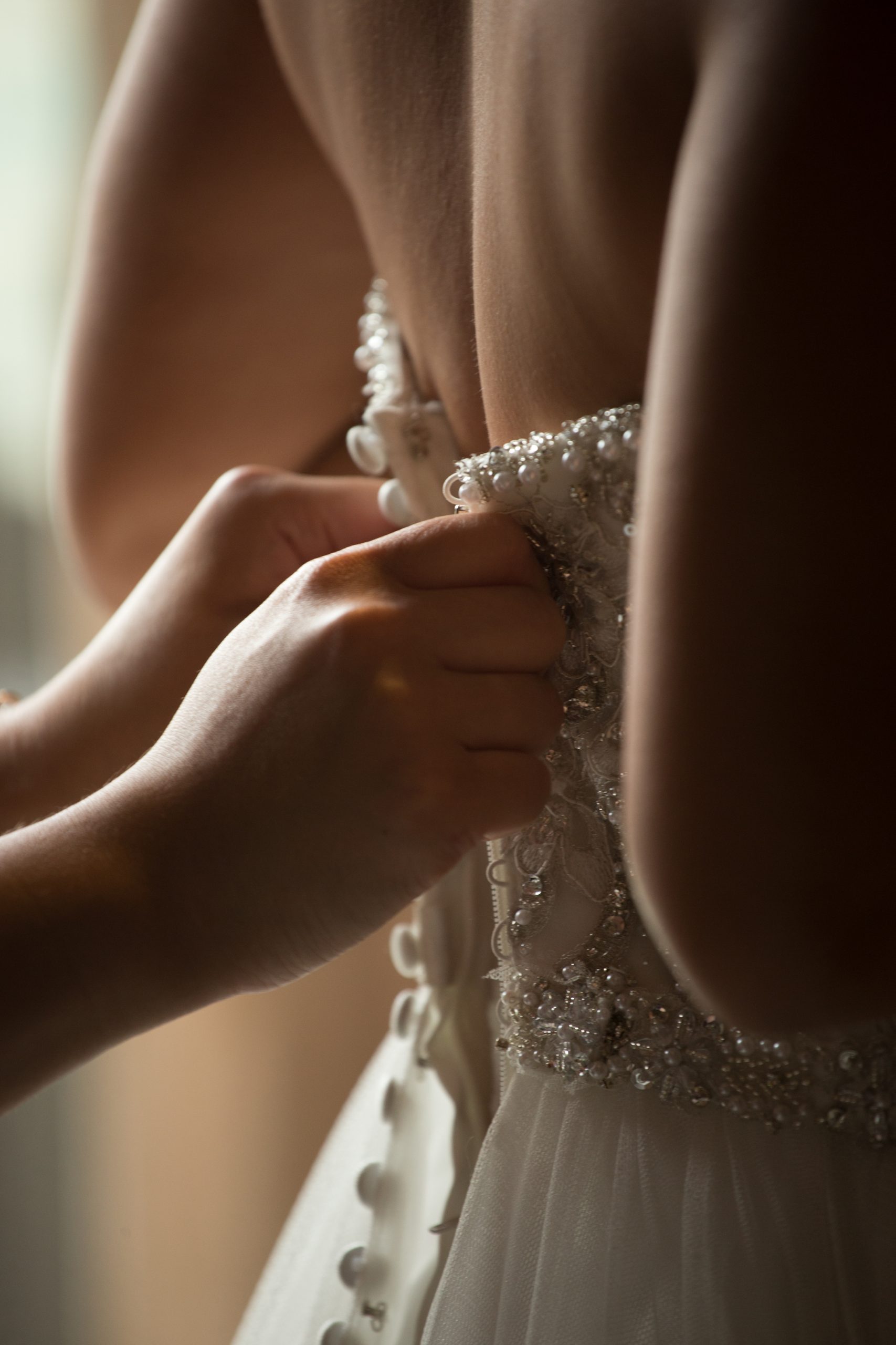 Asian bride help getting dressed