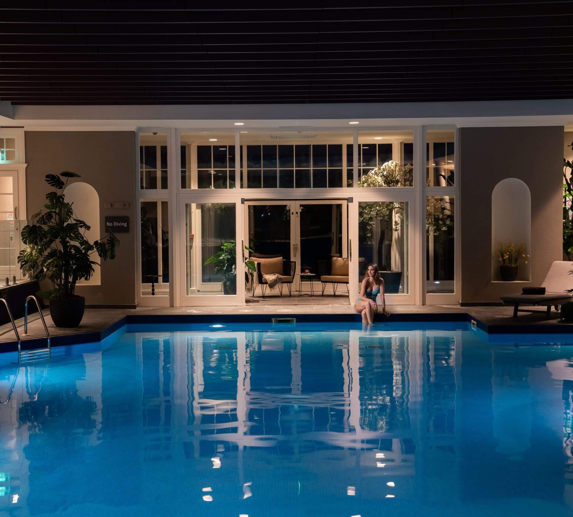 Woman sitting by pool at Mount Juliet Estate