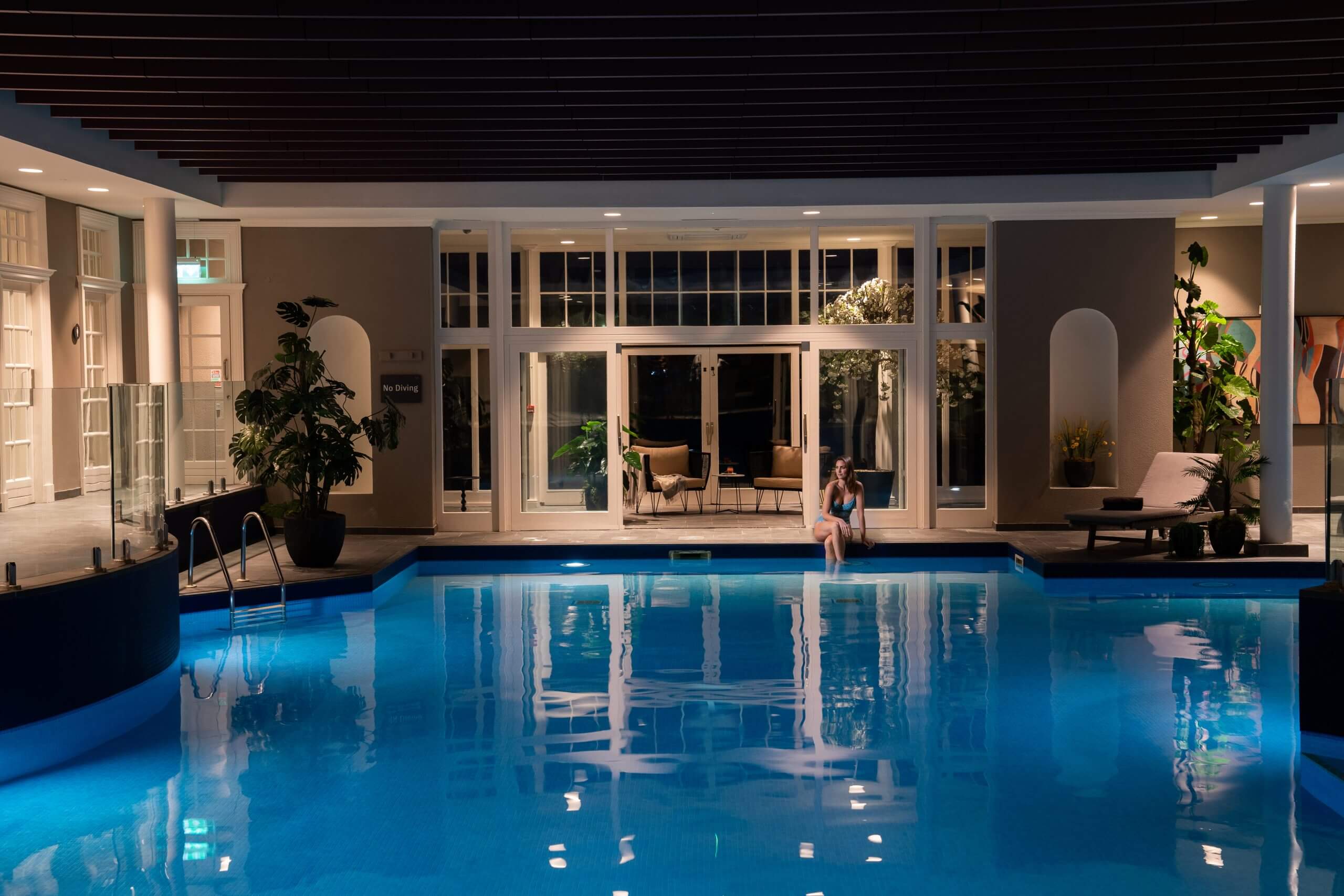 Woman sitting by pool at Mount Juliet Estate